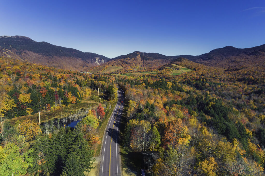 Road leading to ski resort in Stowe, Vermont. Aerial view with fall scenery