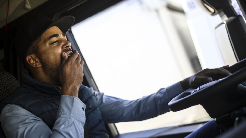 Truck driver yawning. About 35 years old, African male.